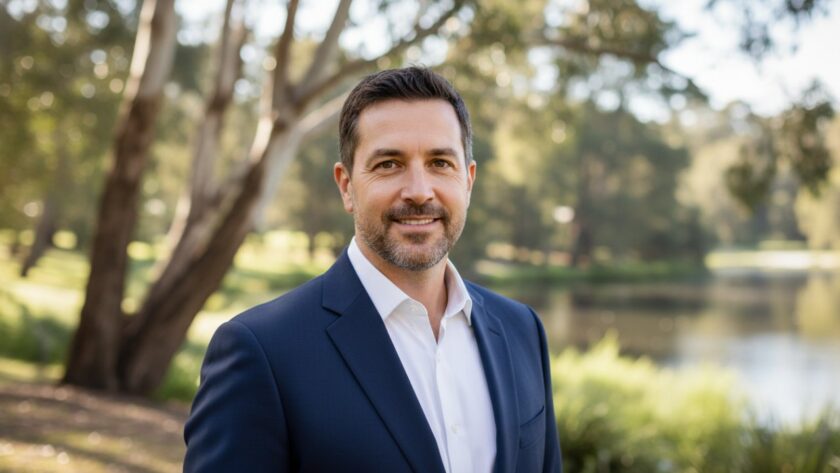 A dynamic and professional corporate headshot of a confident business person against a blurred backdrop of the serene Badger Creek landscape at sunset, emphasizing professional Badger Creek corporate headshots professional.