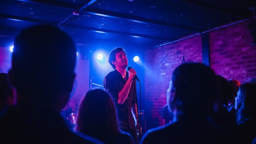 A dynamic, wide-angle shot capturing the lead singer bathed in vibrant stage lights during an electrifying performance at a Belgrave South venue, perfectly illustrating Belgrave South live music photography unforgettable moments.