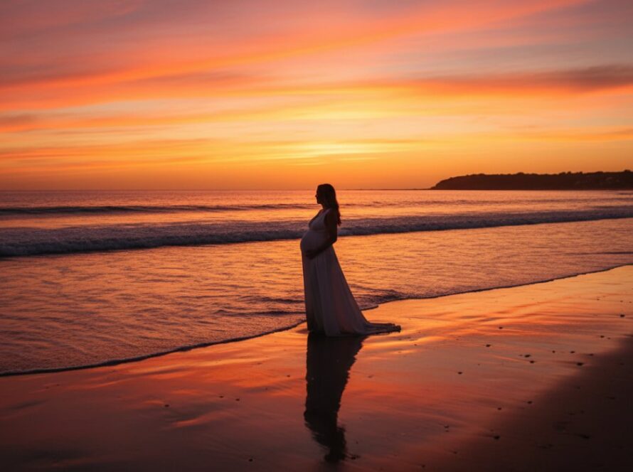 Epic Capel Sound Maternity Photography Beachfront Portraits featuring a glowing expectant mother at sunset, standing gracefully by the gentle waves with the stunning coastline in the background.