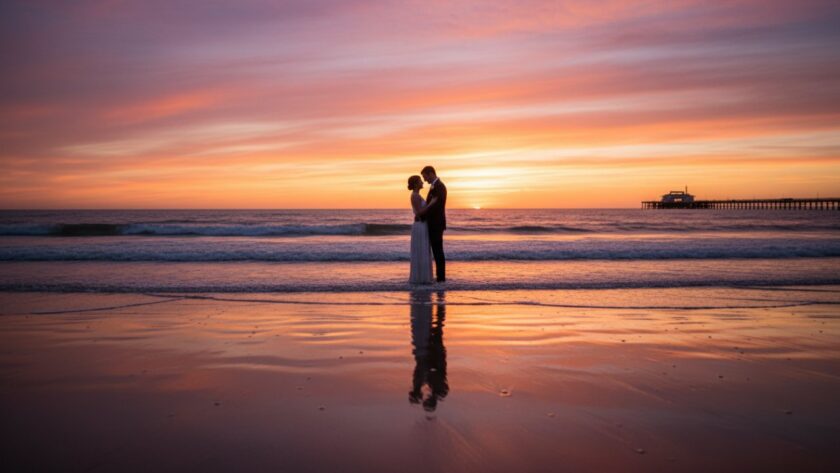 A romantic couple sharing a tender moment on Rosebud Beach at sunset, with golden light reflecting off the calm water, embodying the dreamy Rosebud beach engagement photography aesthetic.