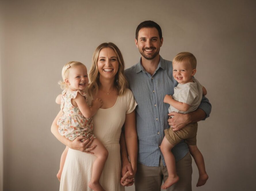 An elegant studio portrait photography Chum Creek Victoria epic moment, featuring a family laughing genuinely in a beautifully lit, modern studio setting, natural light streaming through a large window, warm tones.