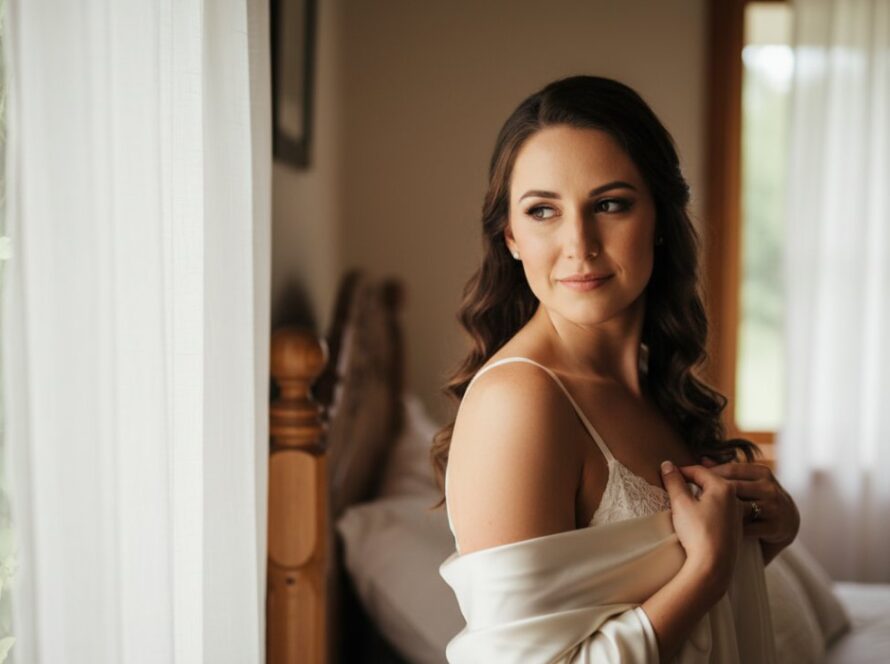 An intimate, epic moment captured during a Healesville Victoria Empowering Boudoir Photography Experience, featuring a woman softly illuminated by natural light, exuding confidence and grace against a backdrop hinting at Healesville's natural beauty.