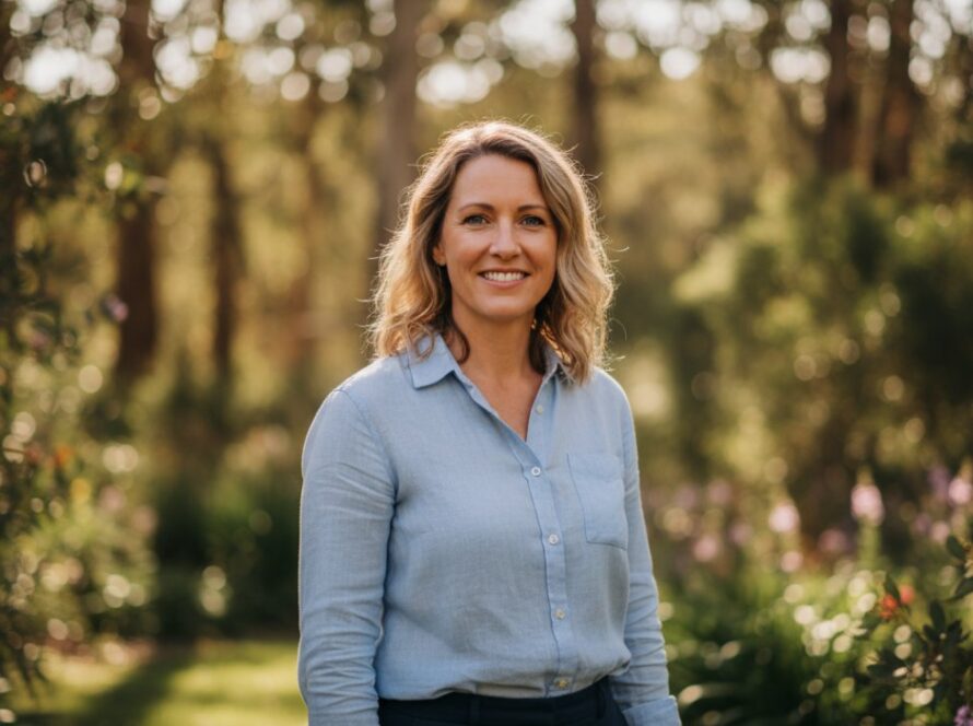A striking Kalorama professional headshot capturing authentic presence, featuring a confident subject smiling genuinely amidst the soft, dappled light of Kalorama's natural bushland, showcasing professionalism and approachability.