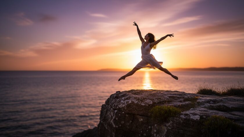 A professional dancer mid-air, silhouetted against a dramatic Mount Eliza sunset during an expressive dance photography session, showcasing powerful movement and grace.