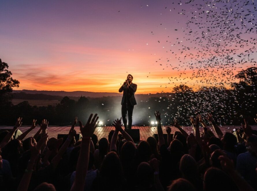 An epic moment captured in Steels Creek intimate live music photography, showcasing a lead guitarist bathed in dramatic stage lighting, mid-solo, with a blurred audience in the background, conveying raw energy and passion.