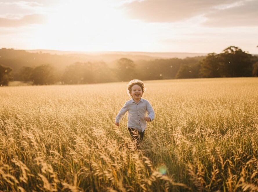 A vibrant Steels Creek kids photography natural light scene showing a young child laughing joyfully amidst sun-dappled trees at sunset, captured in an epic, emotive moment.