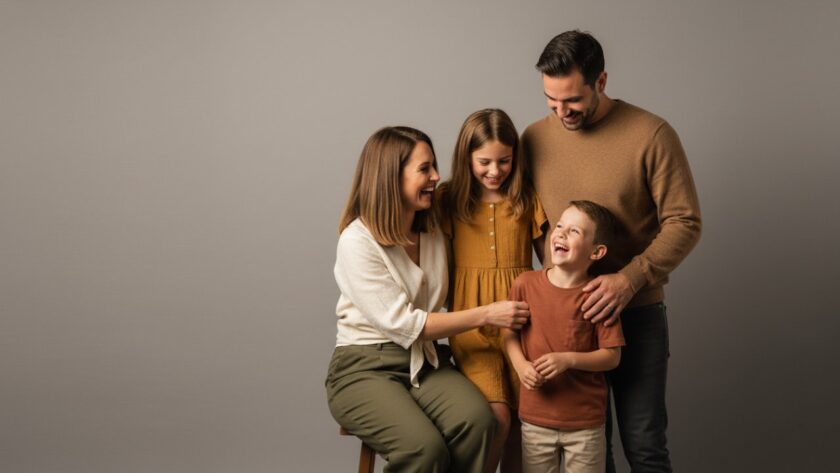 A heartwarming, candid moment captured during a tailored studio photography session in Upwey, featuring a family laughing joyfully, bathed in soft, professional lighting, creating vibrant portraits filled with genuine emotion.