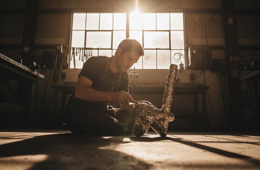 An epic, low-angle shot of a dynamic Ardeer Victoria commercial photography elevating local businesses photoshoot, capturing a local artisan meticulously crafting a product in a sun-drenched workshop, with dramatic lens flare and a blurred industrial Ardeer backdrop, symbolizing growth and craftsmanship.