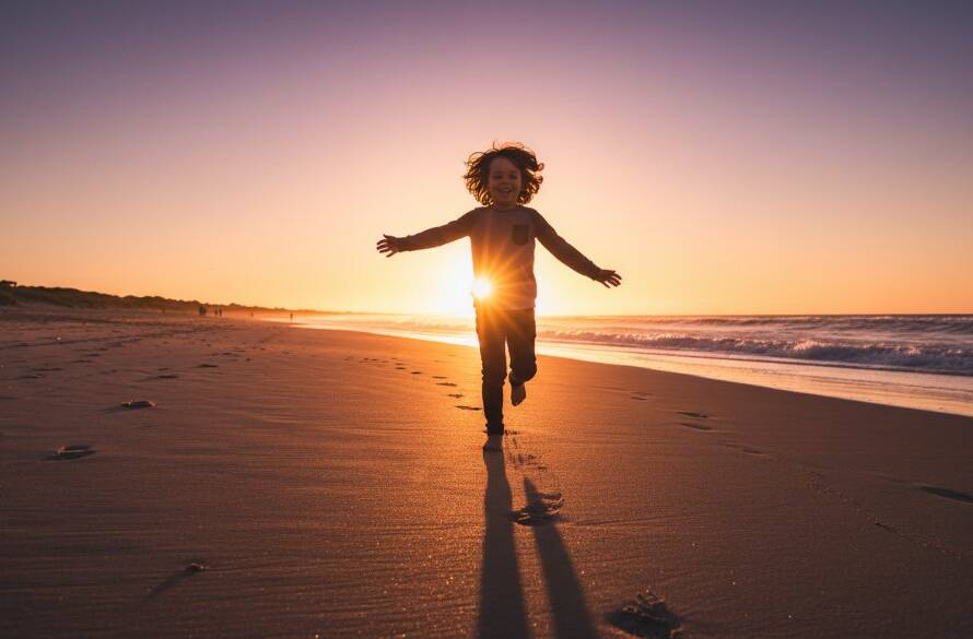 A wide shot of a child mid-laugh, running freely on the golden sands of Aspendale Beach at sunset, capturing an authentic kids photography Aspendale beach candid moment with soft, warm light.