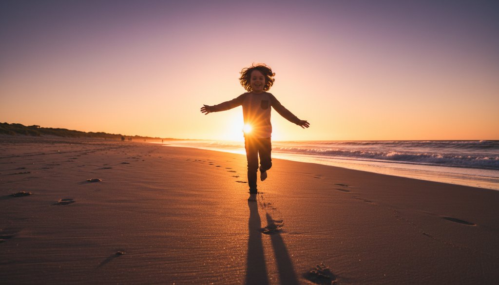 A wide shot of a child mid-laugh, running freely on the golden sands of Aspendale Beach at sunset, capturing an authentic kids photography Aspendale beach candid moment with soft, warm light.