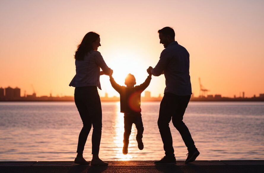 An authentic North Geelong candid family photography moment showing a child laughing joyfully while being lifted by a parent, silhouetted against a golden hour sunset over Corio Bay, capturing genuine connection and happiness.