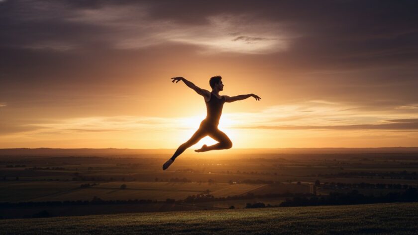 A male ballet dancer executing a powerful, elegant leap against a soft, sunlit backdrop of rolling hills near Bacchus Marsh, captured in a Bacchus Marsh dance photography dynamic portrait with dramatic backlighting and professional colour grading, showcasing an epic moment of athletic grace and artistic expression.