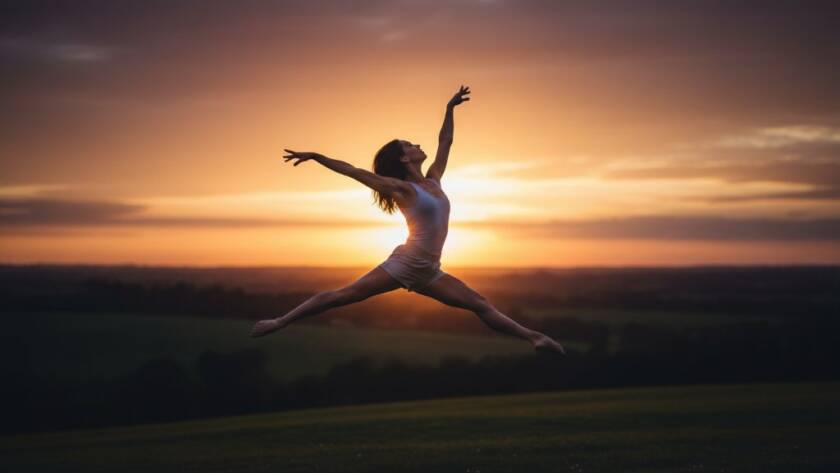 An epic moment of a dancer in Beaconsfield Dance Photography for Elegant Movement, captured mid-air in a powerful leap, silhouetted against a golden sunset over the Beaconsfield hills, showcasing incredible athleticism and grace.