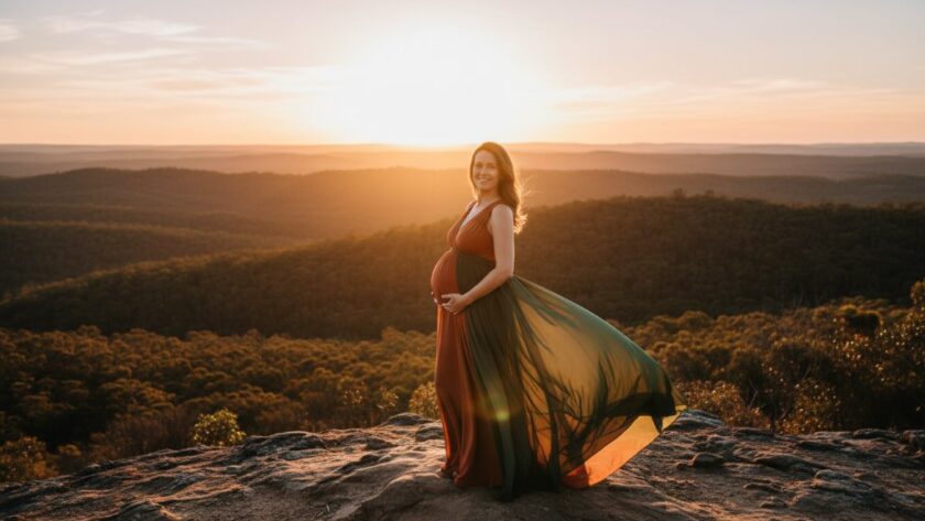 An expectant mother, silhouetted by the golden hour sun, standing gracefully amidst the rolling hills of Black Hill, Victoria, her pregnancy celebrated in a stunning Black Hill maternity photography outdoor glow shot, evoking warmth and anticipation.
