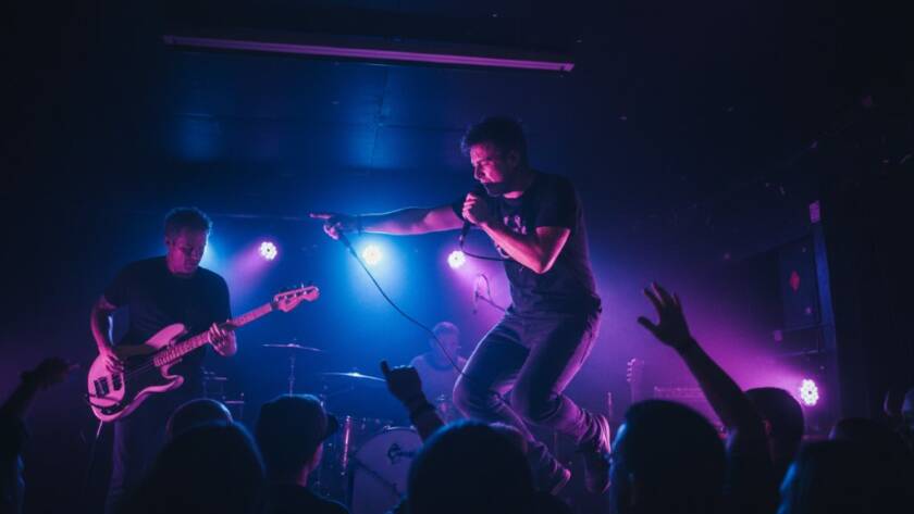 A Boronia live music photography expert captures an epic moment: a lead guitarist in mid-solo, bathed in dramatic stage lighting, with a cheering crowd in silhouette, showcasing the electric energy of a local gig.