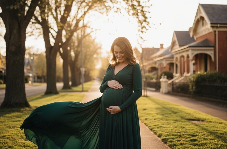 A glowing expectant mother, with a serene smile, stands silhouetted against a dramatic sunset over Lake Wendouree near Soldiers Hill, her hands gently cradling her baby bump, capturing a breathtaking Soldiers Hill maternity photoshoot experience with epic, professional lighting and rich, warm tones.