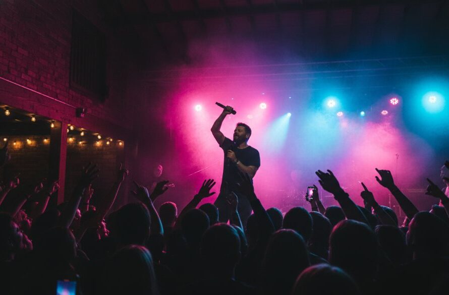 Dynamic close-up shot of a lead guitarist mid-shred at a Buninyong live music photography vibrant local acts concert, bathed in dramatic stage lights, capturing intense emotion and energy.