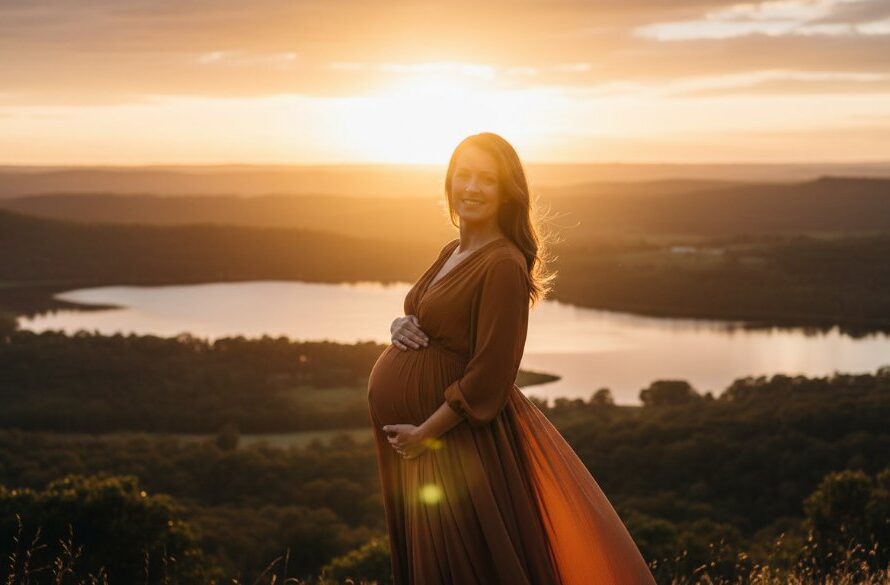A stunning Buninyong maternity photography radiant outdoor portrait at golden hour, featuring an expectant mother in a flowing gown, silhouetted against the iconic scenic backdrop of Buninyong, Victoria, with dramatic, warm light creating an epic, tender moment.