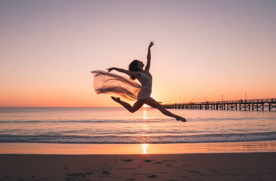 A dramatic wide shot of a contemporary dancer performing an elegant, powerful leap against the golden hour sunset at Seaford Pier, Victoria, embodying 'captivating dance photography Seaford pier Victoria', with the ocean and pier in the background, showcasing dynamic movement and emotional intensity.