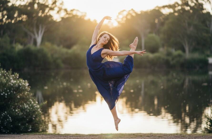 A female contemporary dancer in mid-air, performing an acrobatic leap against a softly blurred natural backdrop at Wilson Botanic Park, Narre Warren South, dramatically lit by golden hour sun, showcasing the capturing dance artistry Narre Warren South Victoria.