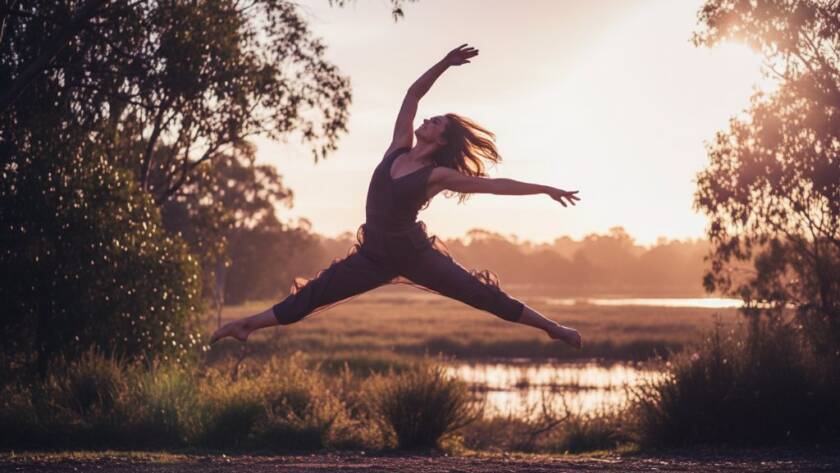A breathtaking wide shot of a dancer mid-leap at golden hour, silhouetted against the iconic natural landscape of Botanic Ridge, showcasing the essence of capturing dynamic dance photography Botanic Ridge Victoria, with dramatic lens flare and professional colour grading.