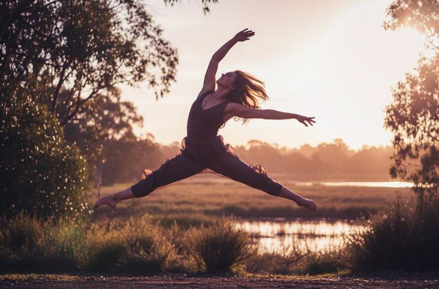 A breathtaking wide shot of a dancer mid-leap at golden hour, silhouetted against the iconic natural landscape of Botanic Ridge, showcasing the essence of capturing dynamic dance photography Botanic Ridge Victoria, with dramatic lens flare and professional colour grading.