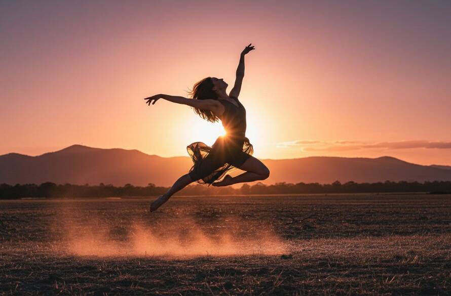 A dramatic, low-angle photograph showcasing a contemporary dancer mid-air in a powerful leap against the golden hour glow of the Dandenong Ranges in Rowville, Victoria, embodying capturing dynamic dance photography Rowville Victoria with professional cinematic lighting.