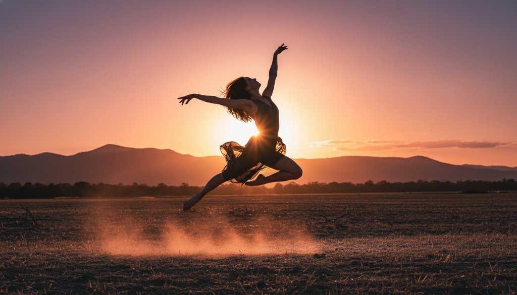 A dramatic, low-angle photograph showcasing a contemporary dancer mid-air in a powerful leap against the golden hour glow of the Dandenong Ranges in Rowville, Victoria, embodying capturing dynamic dance photography Rowville Victoria with professional cinematic lighting.