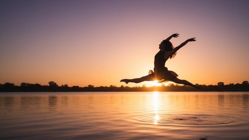 Dynamic wide shot of a ballet dancer mid-air in an awe-inspiring grand jeté, set against a blurred, golden hour Shepparton orchard background, showcasing Capturing dynamic dance photography Shepparton at its best with dramatic lighting.