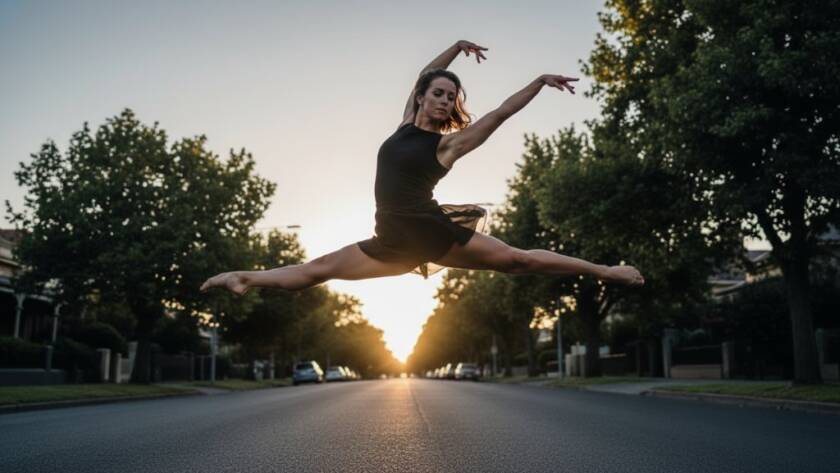 An epic moment of a contemporary dancer captured during a dynamic Mont Albert dance photography session, mid-air in a powerful leap, silhouetted against a dramatic sunset glow near a heritage Mont Albert park.