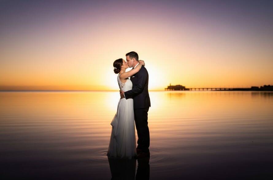A newlywed couple shares an intimate, joyful kiss at sunset on Frankston foreshore, with dramatic golden light, showcasing the magic of Capturing Frankston foreshore wedding magic, professional color grading, cinematic style.