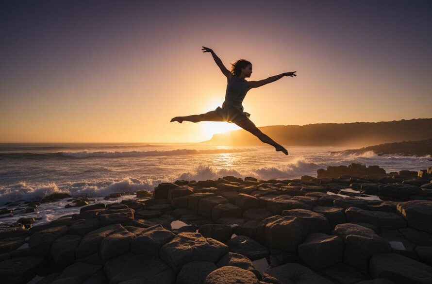 A professional photograph capturing graceful dance Warrnambool coastline: a dancer in mid-leap, silhouetted against a dramatic sunset over the Southern Ocean, evoking an epic moment of artistry and power.
