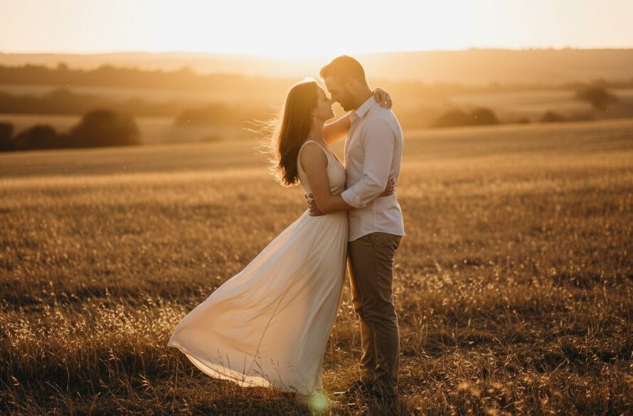 An emotionally resonant and professionally colour-graded cinematic photograph showcasing a couple embracing passionately at sunset in a rustic, golden-lit field near Epsom, Victoria, perfectly capturing heartfelt Epsom engagement photos with dramatic flair.