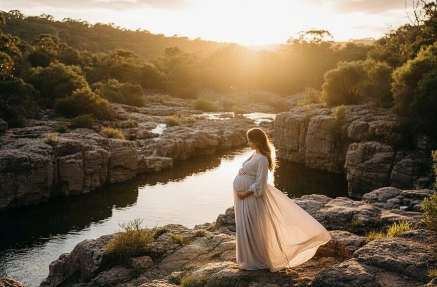 A stunning 'epic moment' style photograph of an expectant mother in Hamlyn Heights, Victoria, showcasing her radiant pregnancy glow against a dramatic sunset backdrop near Buckley Falls. The composition highlights her silhouette and the natural beauty of the surroundings, perfectly capturing radiant maternity photos in Hamlyn Heights Victoria.