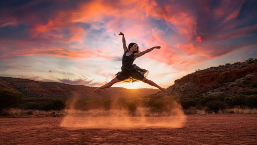 A powerful female dancer mid-air, silhouetted against a dramatic Red Cliffs sunset, performing an exquisite leap, encapsulating Capturing Red Cliffs Dance Movement Photography with grace and strength.