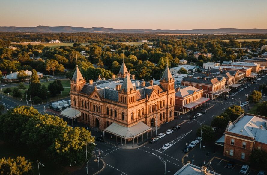 An epic aerial photograph showcasing Castlemaine drone photography capturing heritage beauty, with the historic town bathed in golden hour light, highlighting ornate Victorian architecture and surrounding serene landscapes from a dramatic high angle.
