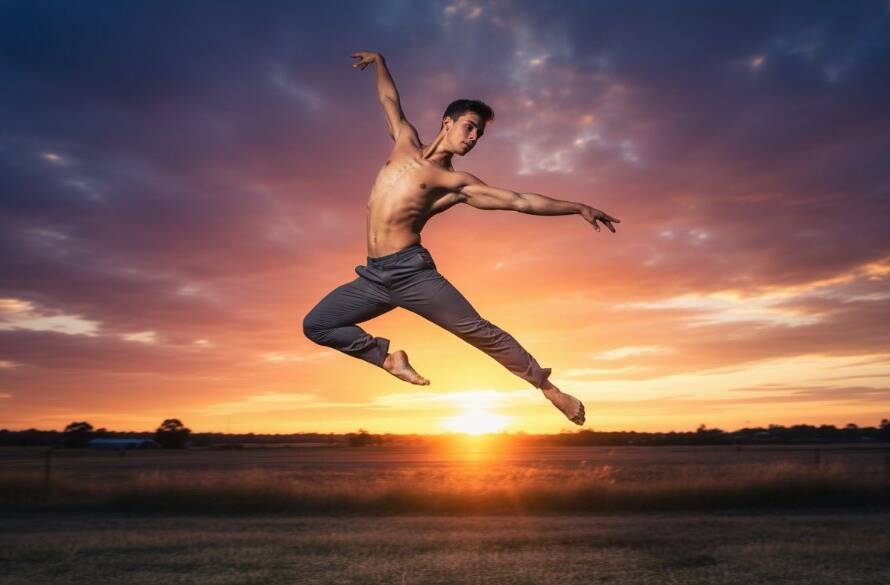 A male contemporary dancer in mid-air, silhouetted against a dramatic sunset over Cranbourne West, showcasing the power and elegance typical of Cranbourne West dynamic dance photography for performing artists. The image is professionally colour-graded with dramatic lighting.