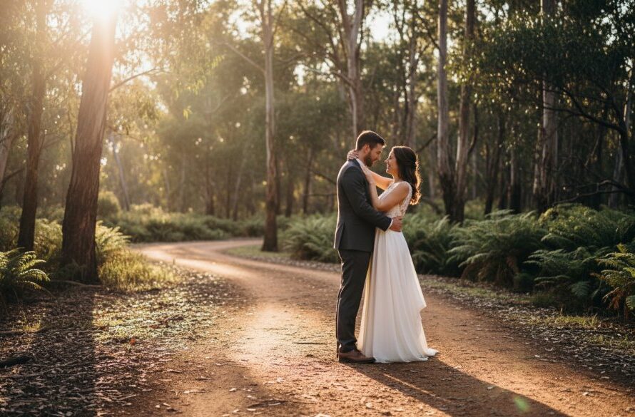 A stunning 'epic moment' photograph capturing Creswick wedding photography heirloom memories: A newly married couple shares a tender, joyful embrace under the dramatic canopy of towering eucalypts near St Georges Lake in Creswick at sunset, light filtering through the leaves, creating a warm, ethereal glow. The image is professionally color-graded and cinematic.