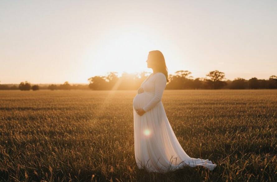 A glowing mother-to-be, silhouetted by the golden hour sun setting over a serene Dandenong South landscape, radiating an unforgettable glow during her Dandenong South maternity photoshoot. Professional, dramatic lighting captures this epic moment.