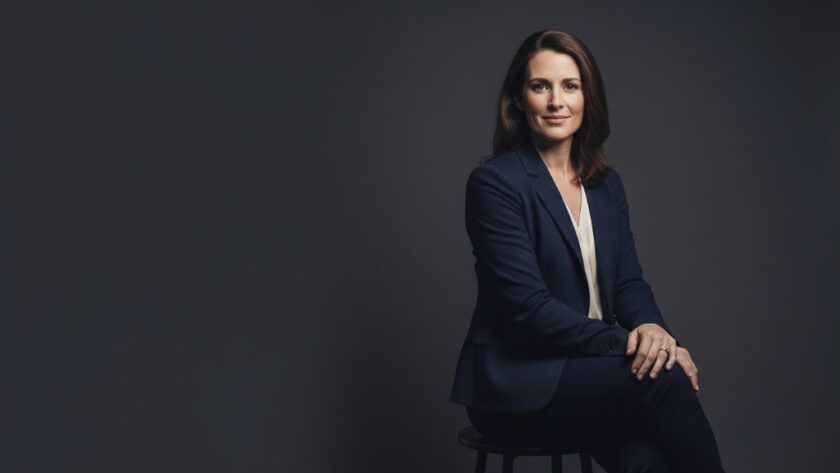 A captivating Daylesford bespoke studio portrait, showcasing a professional woman with a confident smile, dramatic rim lighting highlighting her silhouette against a dark background, evoking a powerful and inspiring epic moment.