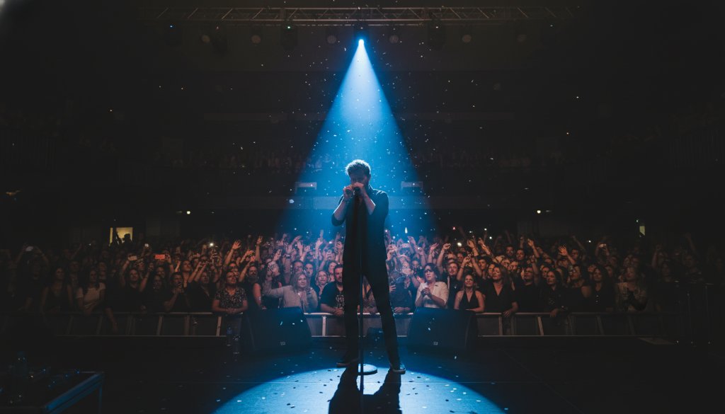 A wide-angle, dramatic shot of a lead guitarist mid-shred under intense stage lights at a vibrant Mount Clear music venue, capturing the immense dynamic concert photography Mount Clear musical energy, with the crowd visible as a blur of adoration in the foreground.