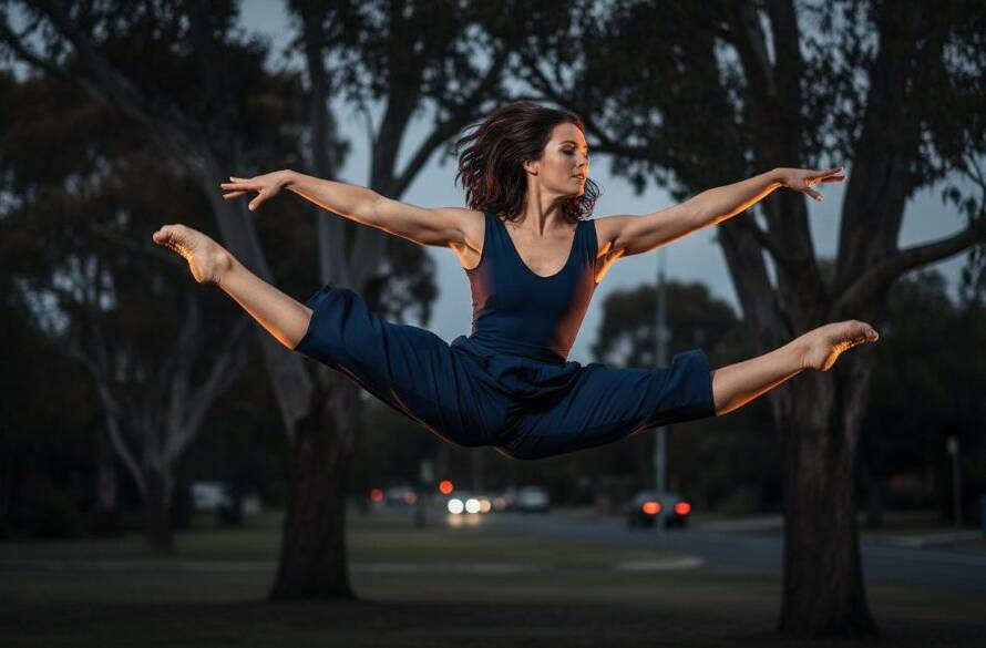 An epic moment of dynamic contemporary dance photography Ashwood, featuring a dancer suspended mid-air in a powerful leap against a dramatically lit dusk backdrop in a quiet Ashwood park, showcasing incredible athleticism and grace with professional colour grading.