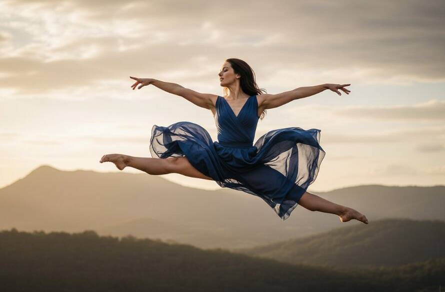 A stunning, low-angle shot capturing the dynamic dance photography artistry of a female dancer mid-air, silhouetted against a dramatic sunset over the Dandenong Ranges near Upper Ferntree Gully, showcasing incredible strength and grace with professional lighting.