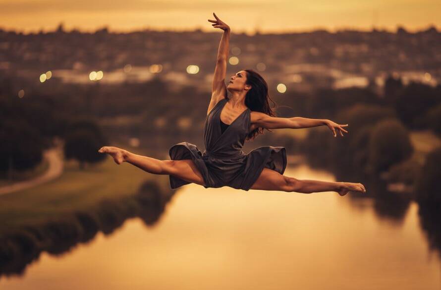 A professional photograph showcasing a male dancer in an electrifying leap, mid-air with incredible power and grace against a slightly blurred, urban Avondale Heights backdrop at dusk, dramatically lit for an epic moment of dynamic dance photography Avondale Heights.