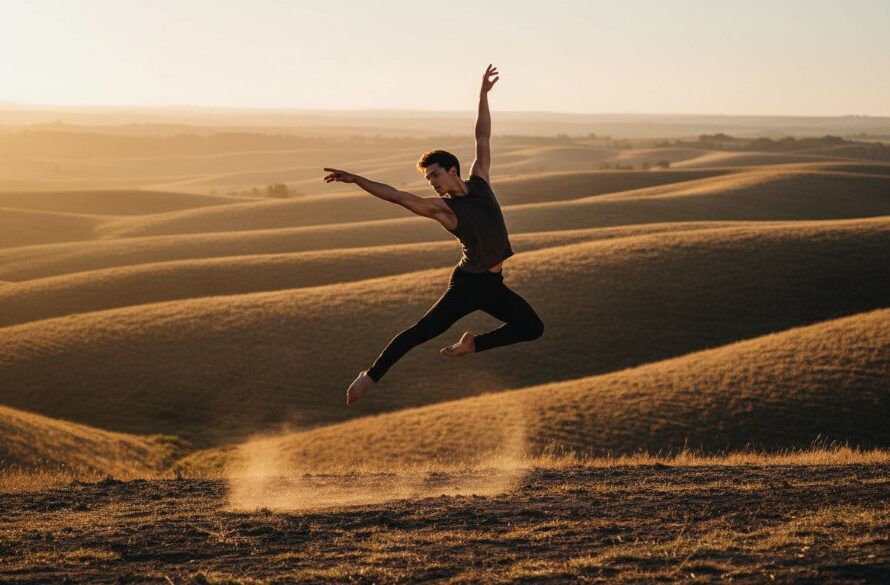 A ballet dancer mid-air, silhouetted against a dramatic sunset over the rolling hills of Brown Hill, Victoria, capturing a truly dynamic dance photography moment with powerful grace and emotional intensity.