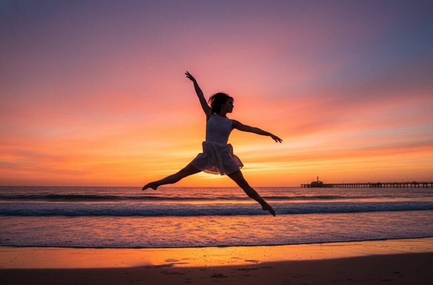 A female dancer in mid-air performing a powerful, graceful leap against the vibrant sunset hues over Carrum foreshore, epitomizing dynamic dance photography Carrum foreshore with dramatic lighting and professional artistry.