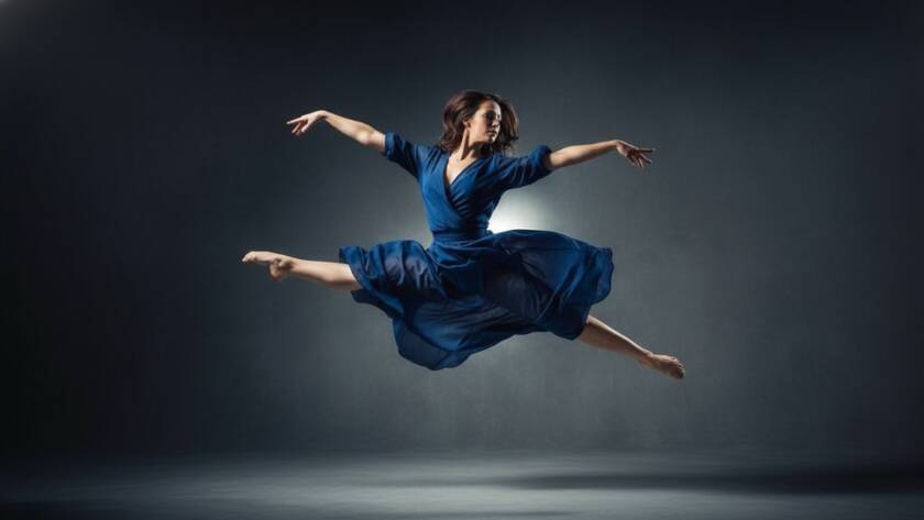 A dancer in mid-air, performing an elegant leap against a dramatic studio backdrop, bathed in theatrical lighting, showcasing dynamic dance photography Langwarrin studio sessions at their peak.