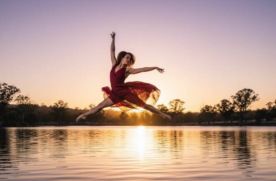 A professional photograph showcasing a dancer in an epic moment of dynamic dance photography Lysterfield Lake, mid-leap against a dramatic sunset, capturing raw power and grace with stunning light.