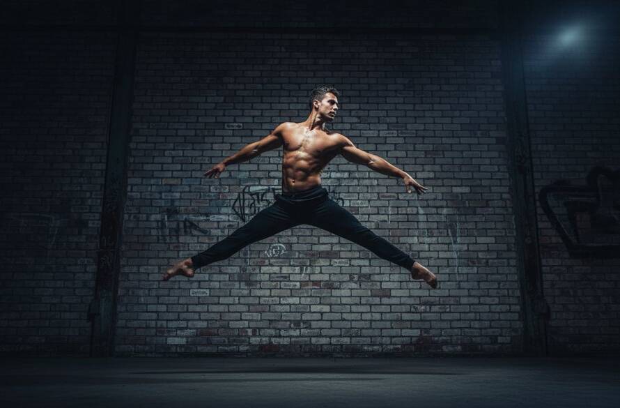 Dynamic dance photography Maribyrnong studios featuring a powerful male dancer mid-leap against a dramatically lit industrial backdrop near the Maribyrnong River, showcasing an epic moment of athletic grace and artistic expression with professional colour grading.