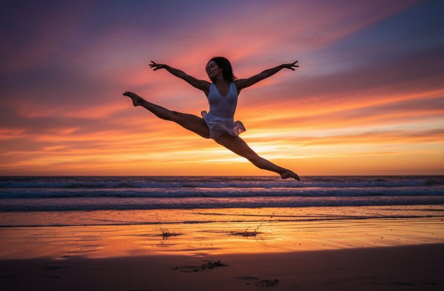 A female contemporary dancer in an exquisite, dynamic pose on the iconic Ninety Mile Beach at sunset in Lakes Entrance, Victoria. Her movement is captured mid-air, silhouetted against a dramatic orange and purple sky, with the waves crashing gently in the background. Professional color grading enhances the cinematic mood. This epic moment showcases the artistic beauty of dynamic dance photography sessions Lakes Entrance.
